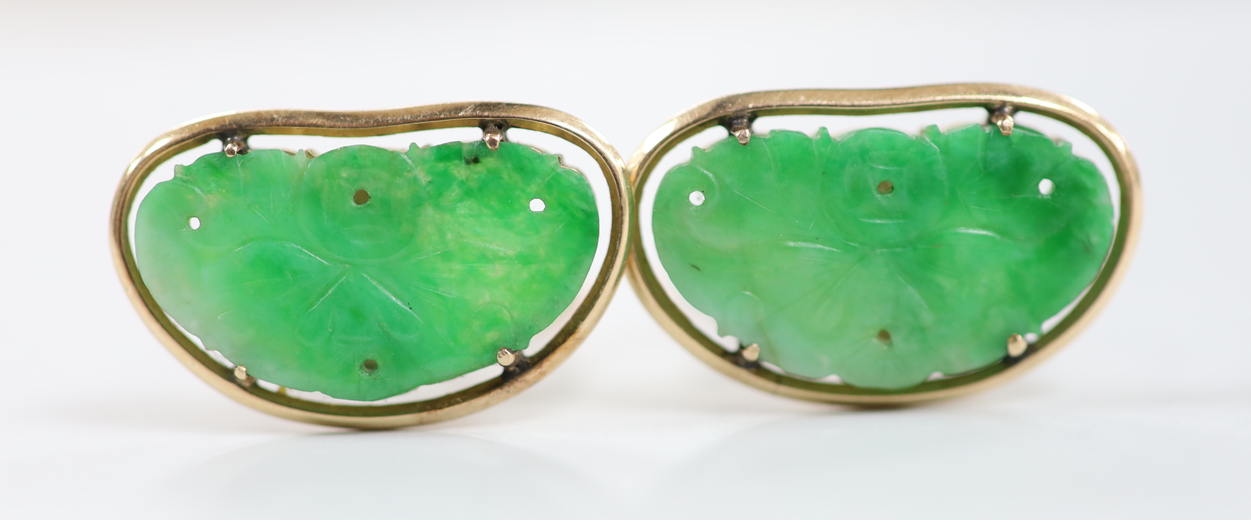 A pair of Chinese yellow metal mounted carved green jade cufflinks, 23mm, together with a further pair of planished yellow metal cufflinks, gross weight 15.3 grams.